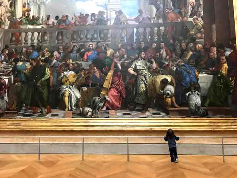 Boy admiring art at The Louvre-Paris. 5-day itinerary in Paris with kids