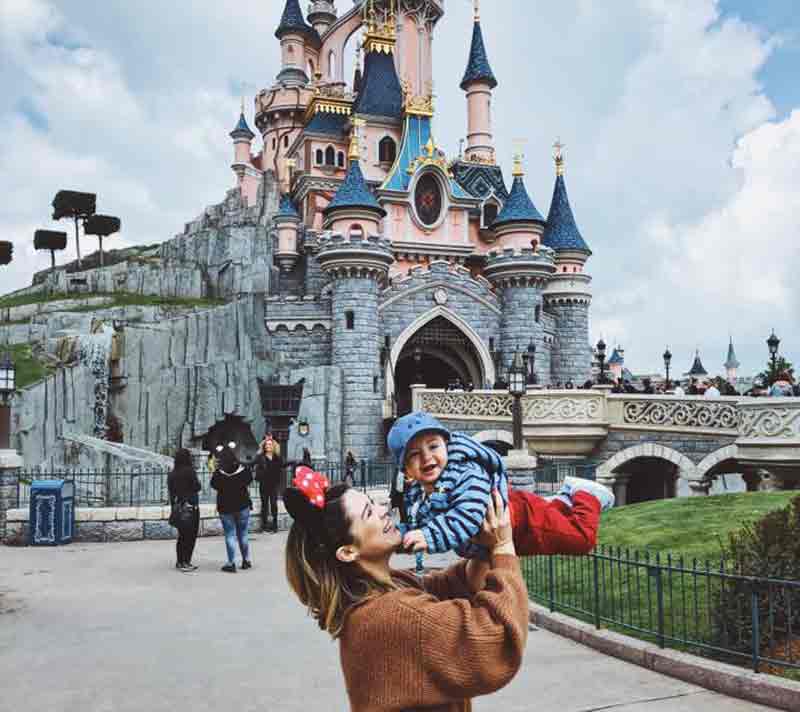 Mother holding a child in front of Disneyland, Paris. 5-day itinerary in Paris with kids