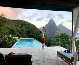 Father holding a baby in St Lucia landscape background